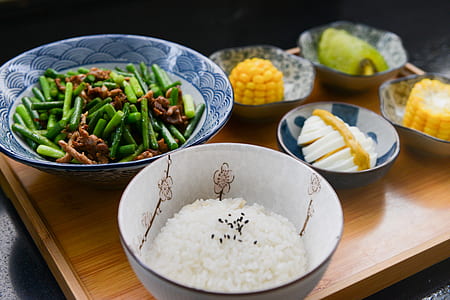Rice on Bowl, Sliced-egg, Corn, and Vegetable on Table thumbnail