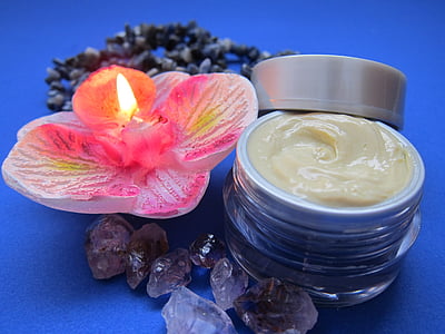 pink lighted flower candle beside cream thumbnail
