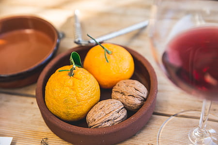 bowl of orange fruits and walnuts thumbnail