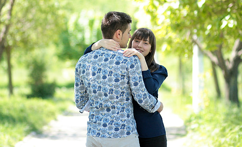 man hugging woman on road thumbnail