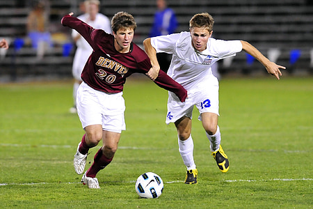 football players playing on field thumbnail