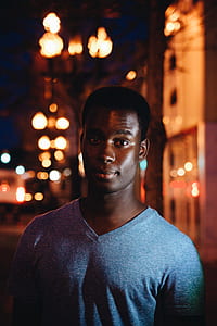 shallow focus photography of man wearing gray V-neck shirt thumbnail