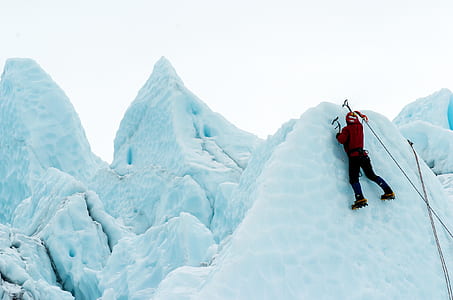 person climbing snow covered mountain thumbnail