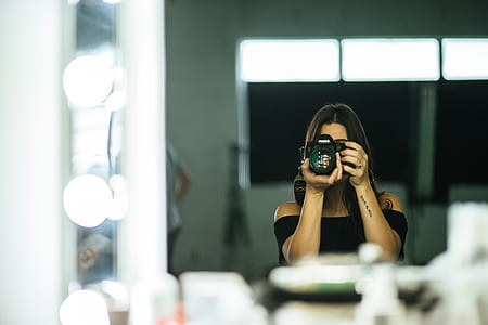 woman taking photo in front of the mirror thumbnail