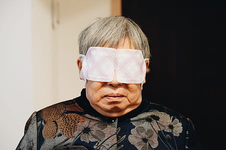 person blindfold near white wall thumbnail