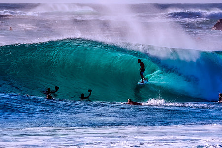 people surfing the waves during daytime thumbnail