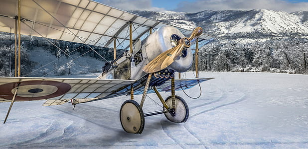 gray monoplane on show mountain thumbnail