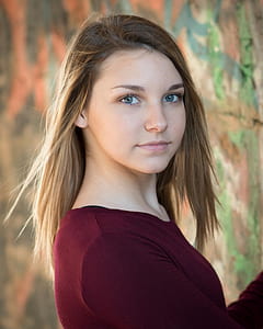 blonde haired woman in maroon top thumbnail