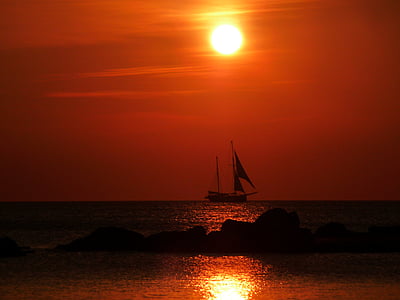 silhouette photo of sailboat on body of water during golden hour thumbnail