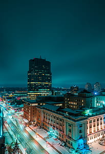 white and black multi-story building under nighttime sky long exposure photography thumbnail