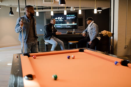 Man in Blue Denim Jacket Holding Cue Stick thumbnail