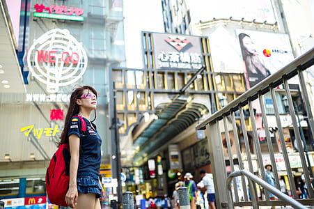 woman standing near buildings during daytime thumbnail