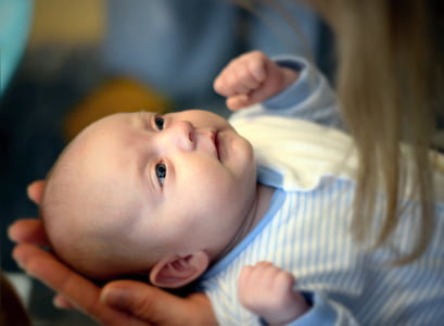 baby wearing white and blue striped top thumbnail