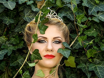 woman standing near green leafed plants thumbnail