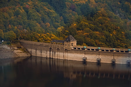 gray concrete bridge near trees during daytime thumbnail