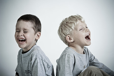photography of two children wearing heather gray shirts while laughing thumbnail
