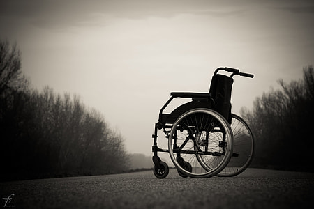 grayscale photography of wheel chair on road thumbnail