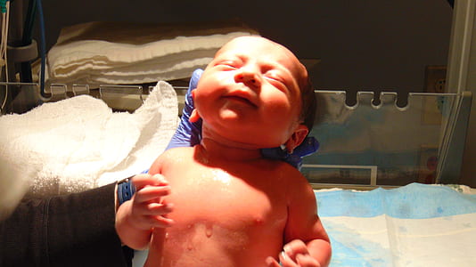 person carrying newborn baby thumbnail