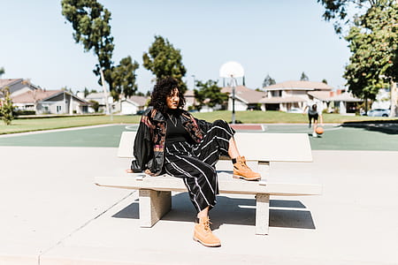 woman sits on white bench thumbnail