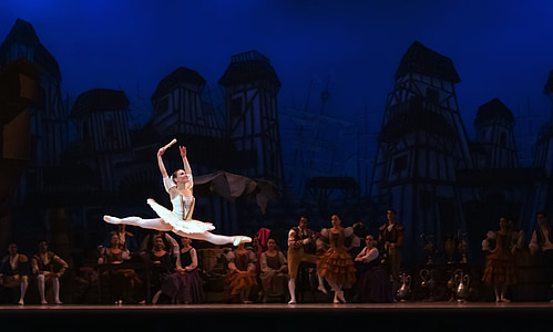 photography of ballet dancer jumping on stage thumbnail