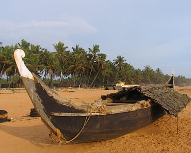 brown wooden canoe boat on seashore thumbnail