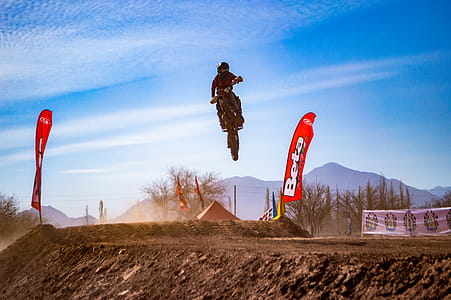 Man Riding Motocross Dirt Bike Doing Stunt thumbnail