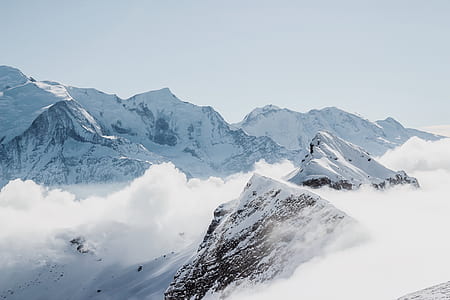 snow-capped mountains with clouds during daytime thumbnail