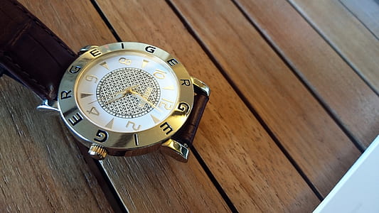 round white analog watch on table thumbnail