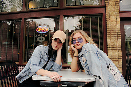 two women sitting on chairs thumbnail