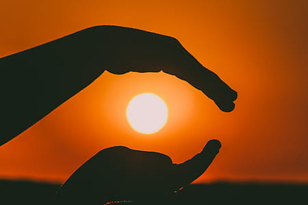 Silhouette of Person's Hands during Sunset thumbnail