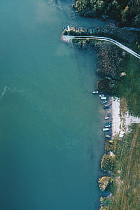 aerial photography of boats docked on the beach during daytime thumbnail