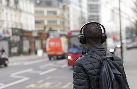 selective focus photography of man standing beside road thumbnail