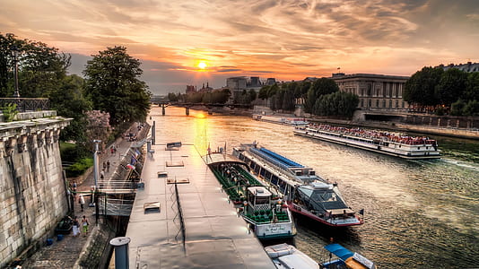 boats on river near trees during sunset thumbnail