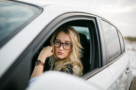 selective focus photography of woman sitting inside vehicle thumbnail