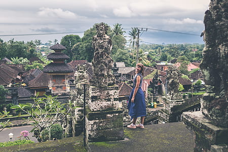 woman standing in front of statue thumbnail