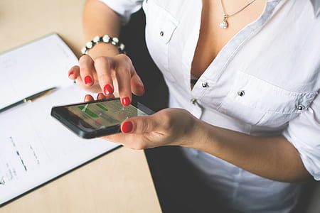 Woman in White Button Up Top and Holding Black Android Smartphone thumbnail