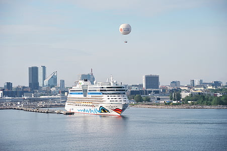 crew ship on body of water near cityscape thumbnail