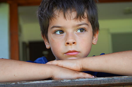 closeup photo of boy looking outside thumbnail