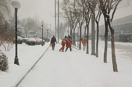 people walking near lamppost covered with snow on street thumbnail