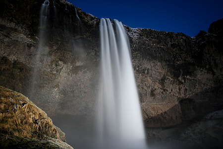 waterfalls inder indigo sky at nightime thumbnail