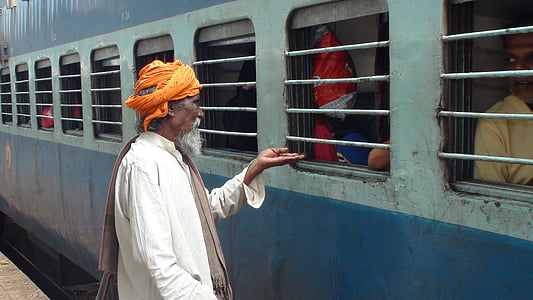 man wearing turban standing in front of train thumbnail