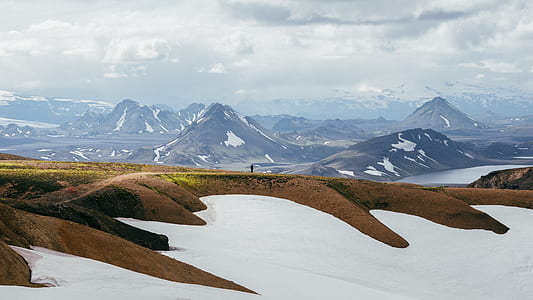 person standing on pathway near mountain thumbnail