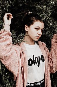 standing woman wearing pink coat during daytime thumbnail