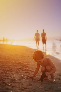 child playing beside seashore thumbnail