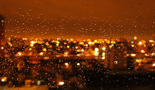 water droplets on clear glass window during night time thumbnail