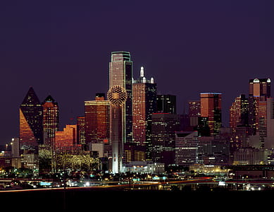Brown Building With Lights on During Night Time thumbnail