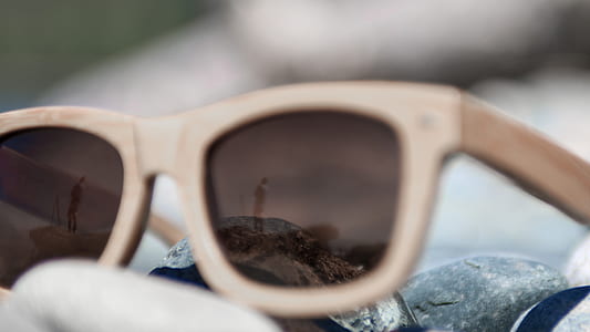 close-up photo of brown framed sunglasses on rack thumbnail