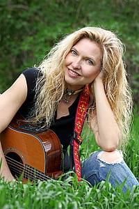 woman sits on grass thumbnail