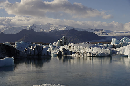 photo of body of water with ice formations thumbnail