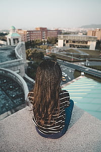 toddler sitting on ledge overlooking city thumbnail